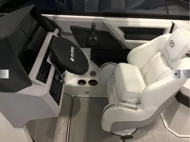 Slide: The Image of 2024 Cobalt R8 boat interior with white captain's chair and modern dashboard. - 9