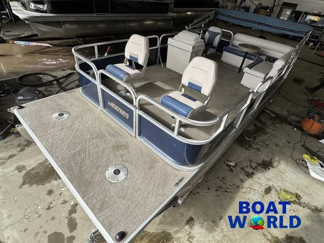 Slide: The Image of 2012 Weeres Cadet 200 Pontoon boat in a showroom, featuring spacious seating. - 1