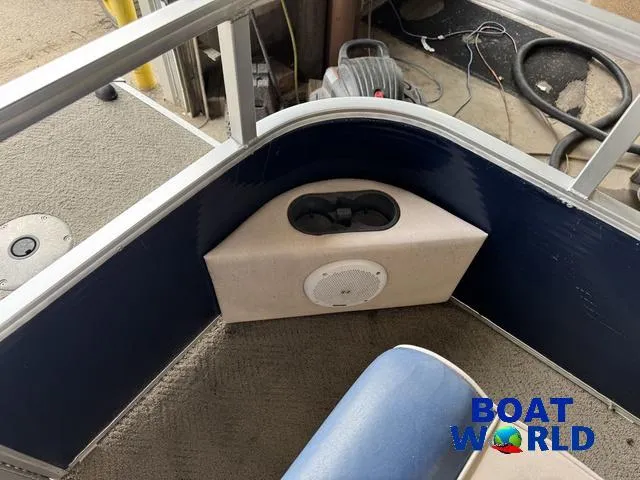 Slide: The Image of 2012 Weeres Cadet 200 Pontoon interior with speaker and cup holder, Boat World logo visible. - 13