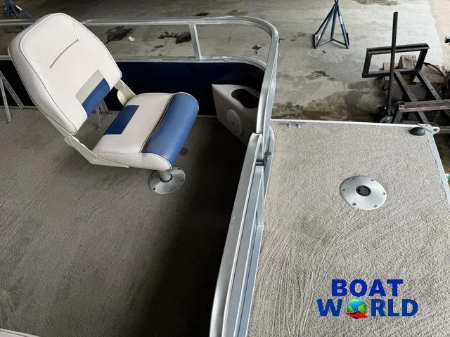 Slide: The Image of 2012 Weeres Cadet 200 Pontoon interior with seating and carpeted deck, Boat World logo visible. - 14