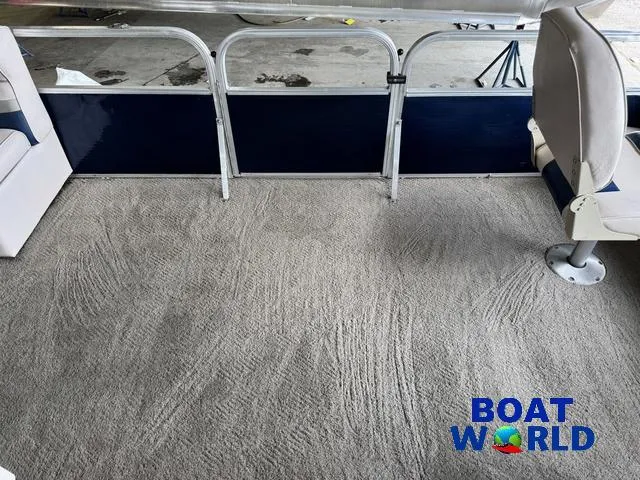 Slide: The Image of 2012 Weeres Cadet 200 Pontoon interior with carpeted floor and seating, Boat World logo visible. - 19