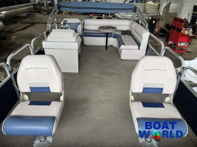 Slide: The Image of 2012 Weeres Cadet 200 Pontoon interior with seating and table, showcased at Boat World. - 2