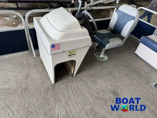 Slide: The Image of 2012 Weeres Cadet 200 Pontoon interior with steering console and seating, featuring Boat World logo. - 21