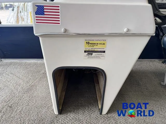 Slide: The Image of 2012 Weeres Cadet 200 Pontoon with American flag and capacity label, displayed at Boat World. - 22