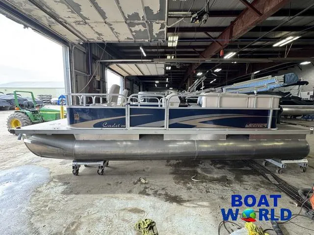 Slide: The Image of 2012 Weeres Cadet 200 Pontoon boat in a warehouse, side view. - 27