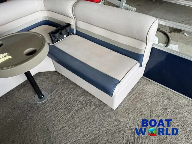 Slide: The Image of 2012 Weeres Cadet 200 Pontoon interior with seating and table, Boat World logo visible. - 28
