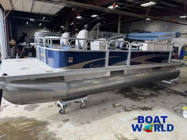 Slide: The Image of 2012 Weeres Cadet 200 Pontoon boat in a workshop, featuring blue and white design. - 33