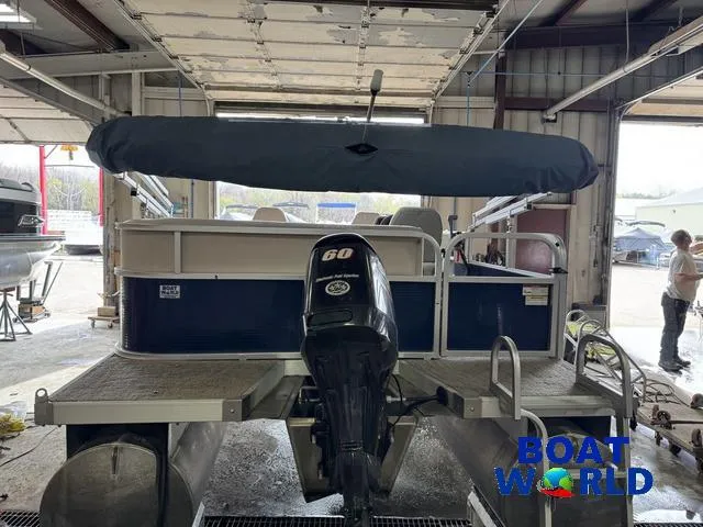 Slide: The Image of 2012 Weeres Cadet 200 Pontoon with 60 HP motor in a garage setting. - 36