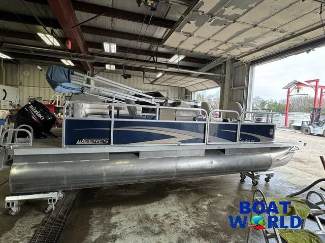 Slide: The Image of 2012 Weeres Cadet 200 Pontoon in a garage, side view, with blue and silver design. - 39