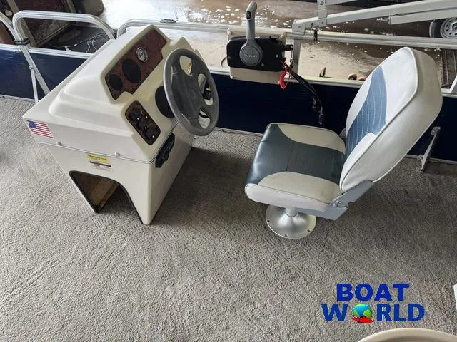 Slide: The Image of 2012 Weeres Cadet 200 Pontoon boat interior with steering console and captain's chair. - 4