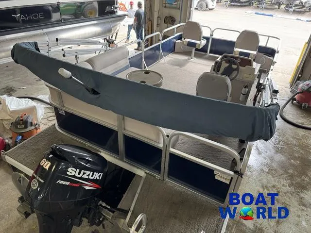 Slide: The Image of 2012 Weeres Cadet 200 Pontoon with Suzuki motor in a garage setting. - 6