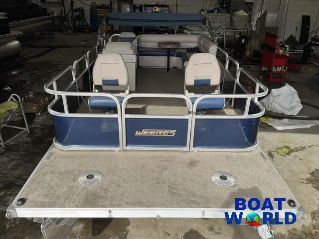 Slide: The Image of 2012 Weeres Cadet 200 Pontoon boat in a workshop setting. - 7