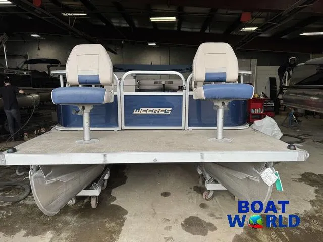 Slide: The Image of 2012 Weeres Cadet 200 Pontoon boat with dual seats in a showroom. - 8