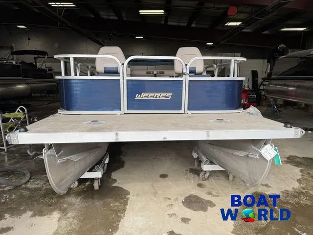 Slide: The Image of 2012 Weeres Cadet 200 Pontoon boat in a showroom, featuring blue and silver design. - 9