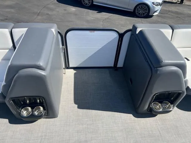 Slide: The Image of 2021 Manitou 23 Aurora LE VP boat interior with gray seating and cup holders. - 10