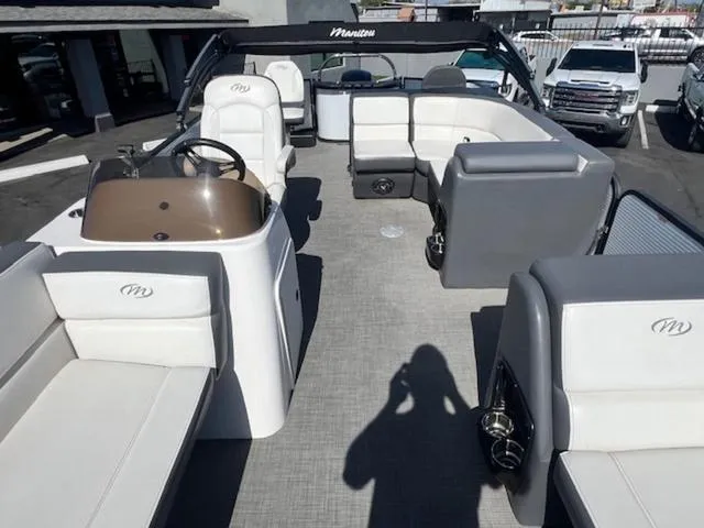 Slide: The Image of 2021 Manitou 23 Aurora LE VP pontoon boat interior with spacious seating and steering console. - 13