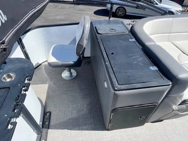 Slide: The Image of 2021 Manitou 23 Aurora LE VP boat interior with seating and storage compartments. - 14