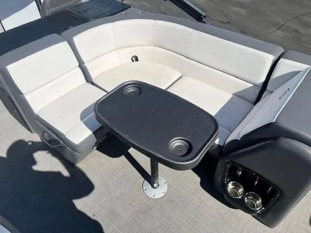 Slide: The Image of 2021 Manitou 23 Aurora LE VP boat interior with seating and table. - 16