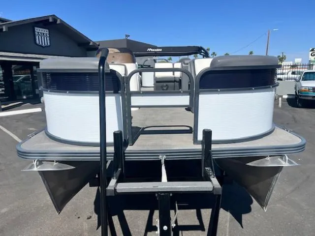 Slide: The Image of 2021 Manitou 23 Aurora LE VP pontoon boat in a parking lot. - 3