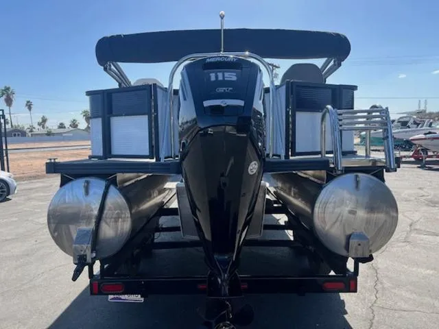Slide: The Image of 2021 Manitou 23 Aurora LE VP pontoon boat with Mercury 115 engine, rear view. - 7