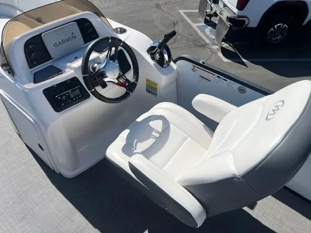 Slide: The Image of Captain's seat and helm of 2021 Manitou 23 Aurora LE VP with Garmin display. - 9