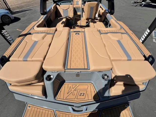 Slide: The Image of 2025 MasterCraft XT23 boat with tan upholstery and sleek design on display. - 10