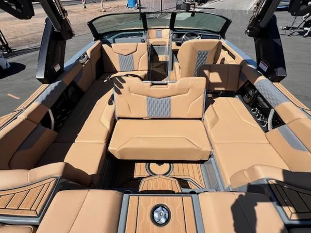 Slide: The Image of 2025 MasterCraft XT23 boat interior with tan leather seating and modern design. - 12