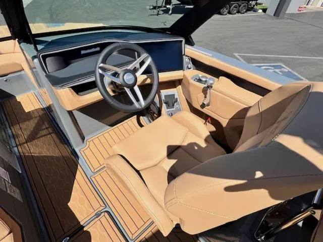 Slide: The Image of 2025 MasterCraft XT23 boat interior with tan leather seats and modern dashboard. - 14