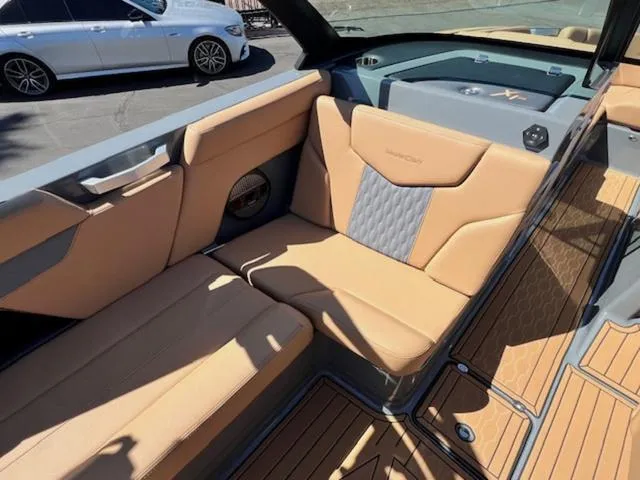 Slide: The Image of 2025 MasterCraft XT23 boat interior with tan leather seats and sleek design. - 15