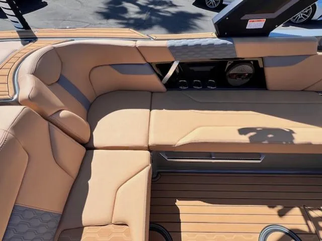 Slide: The Image of 2025 MasterCraft XT23 boat interior with tan seating and modern design. - 16