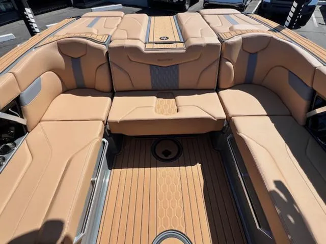 Slide: The Image of 2025 MasterCraft XT23 boat interior with tan seating and sleek design. - 17