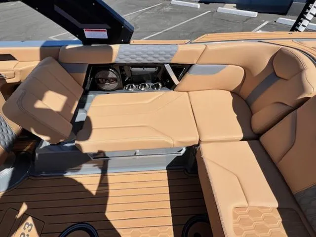 Slide: The Image of 2025 MasterCraft XT23 boat interior with tan leather seating and modern design. - 18