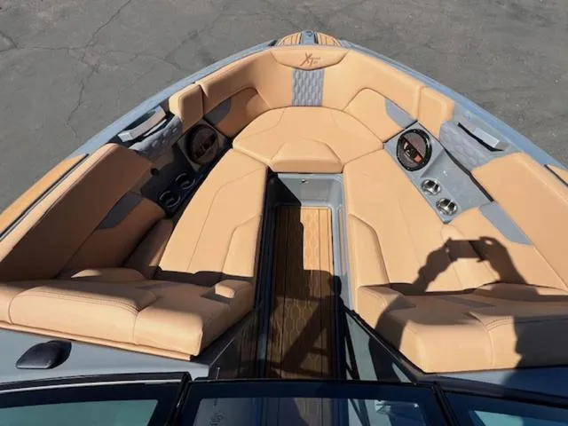 Slide: The Image of 2025 MasterCraft XT23 boat interior with tan seating and modern design. - 19