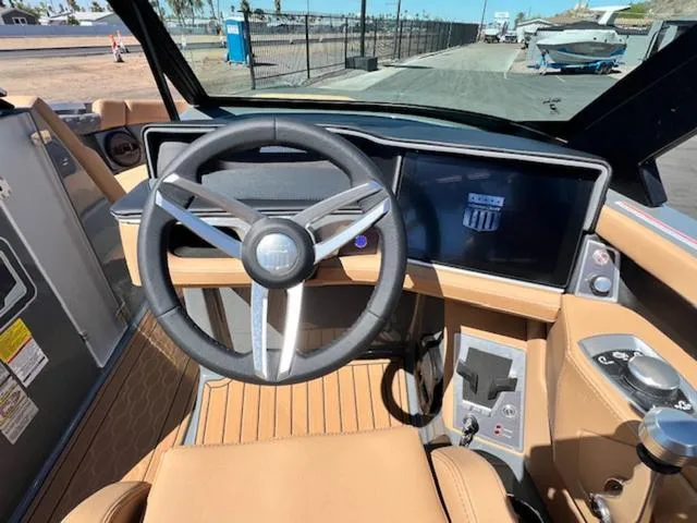 Slide: The Image of 2025 MasterCraft XT23 boat interior with modern dashboard and steering wheel. - 21