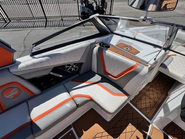 Slide: The Image of 2017 Tigé RZX2 boat interior with orange accents and diamond-stitched seating. - 12
