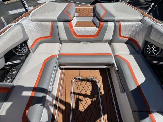Slide: The Image of 2017 Tigé RZX2 boat interior with gray and orange upholstery, featuring diamond stitching and integrated speakers. - 14