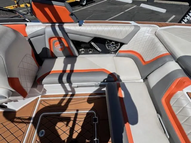 Slide: The Image of 2017 Tigé RZX2 boat interior with orange and gray upholstery, featuring diamond stitching. - 15