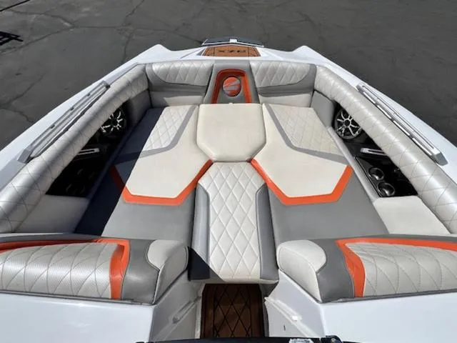 Slide: The Image of 2017 Tigé RZX2 boat interior with gray and orange cushioned seating. - 16