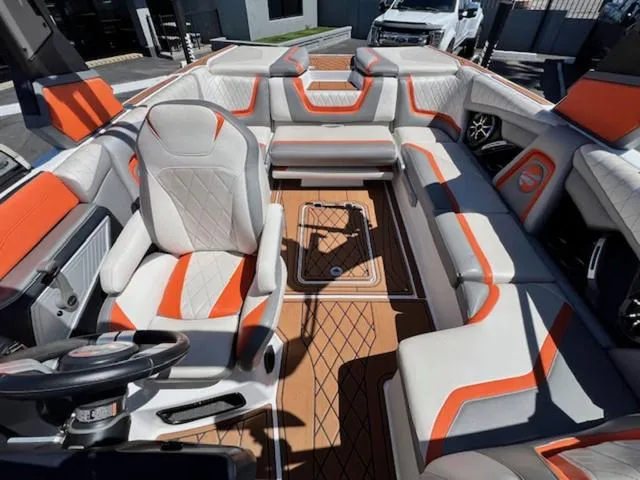 Slide: The Image of 2017 Tigé RZX2 boat interior with orange and gray seating, luxury design. - 17
