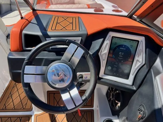 Slide: The Image of 2017 Tigé RZX2 boat dashboard with touchscreen and stylish steering wheel. - 19