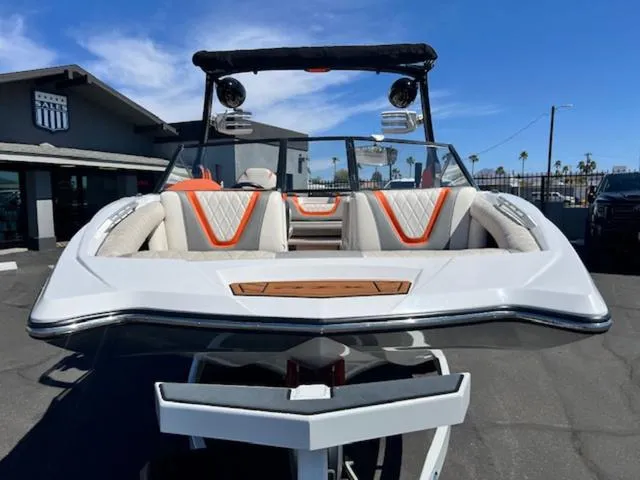 Slide: The Image of 2017 Tigé RZX2 boat with sleek design and vibrant orange accents, parked outdoors. - 3