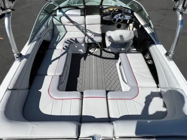 Slide: The Image of 2006 MasterCraft X30 boat interior with white seating and modern dashboard. - 12