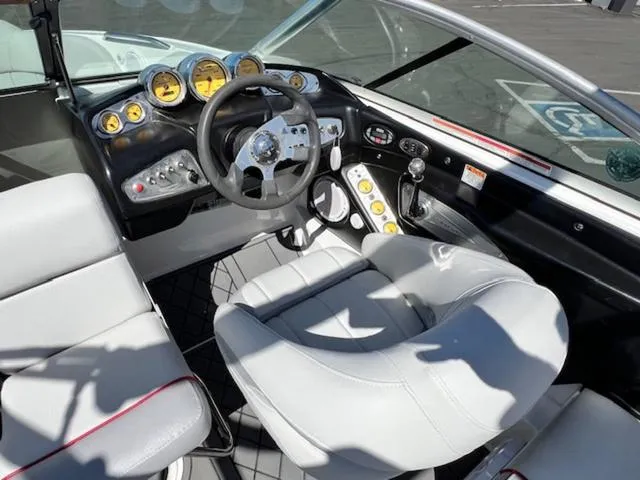 Slide: The Image of 2006 MasterCraft X30 boat interior with steering wheel, gauges, and white seating. - 13