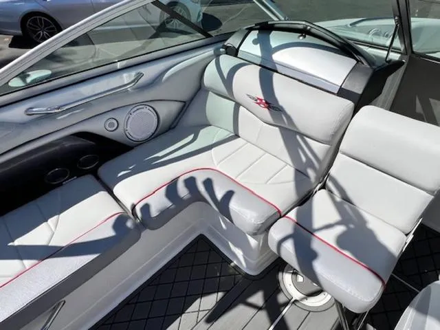 Slide: The Image of 2006 MasterCraft X30 boat interior with white seating and red accents. - 14