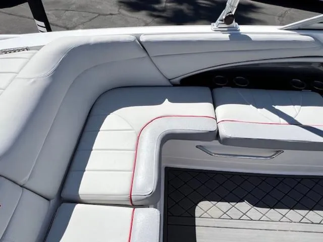 Slide: The Image of 2006 MasterCraft X30 boat interior with white cushioned seating and red accents. - 15