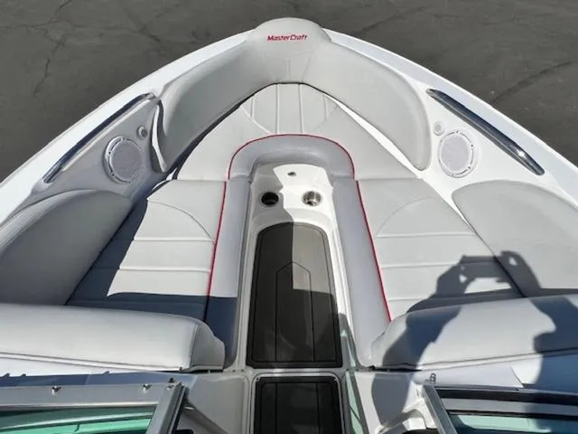 Slide: The Image of 2006 MasterCraft X30 boat interior with gray seating and speaker system. - 18