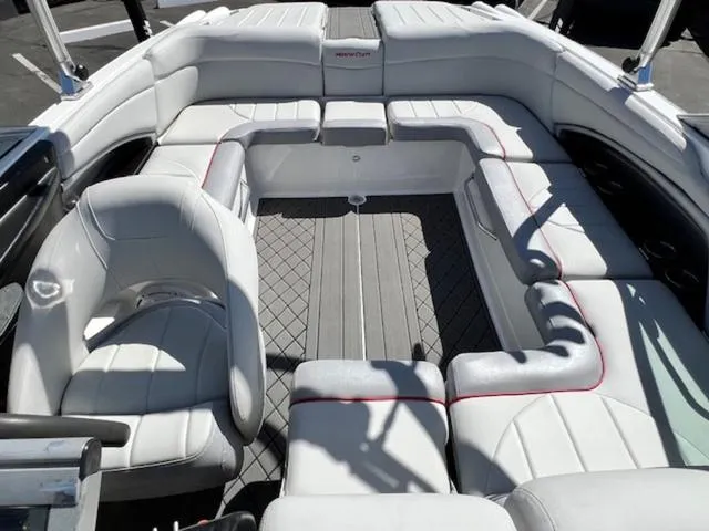 Slide: The Image of 2006 MasterCraft X30 boat interior with white seating and gray flooring. - 19