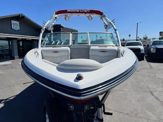 Slide: The Image of 2006 MasterCraft X30 boat with tower, parked outdoors on a sunny day. - 3