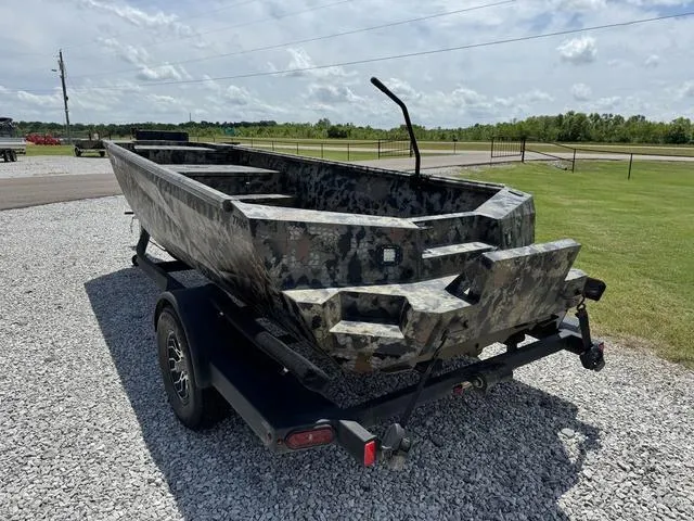 Slide: The Image of 2023 Thor Boats Lake Hammer Standard on trailer, camo design, parked on gravel. - 3