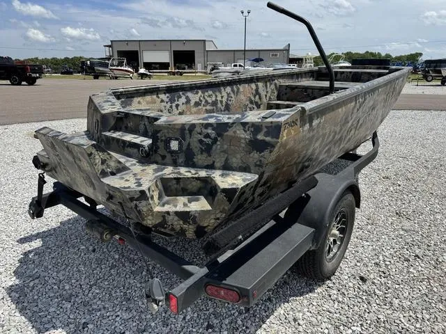 Slide: The Image of 2023 Thor Boats Lake Hammer Standard on trailer, camo design, parked on gravel lot. - 4